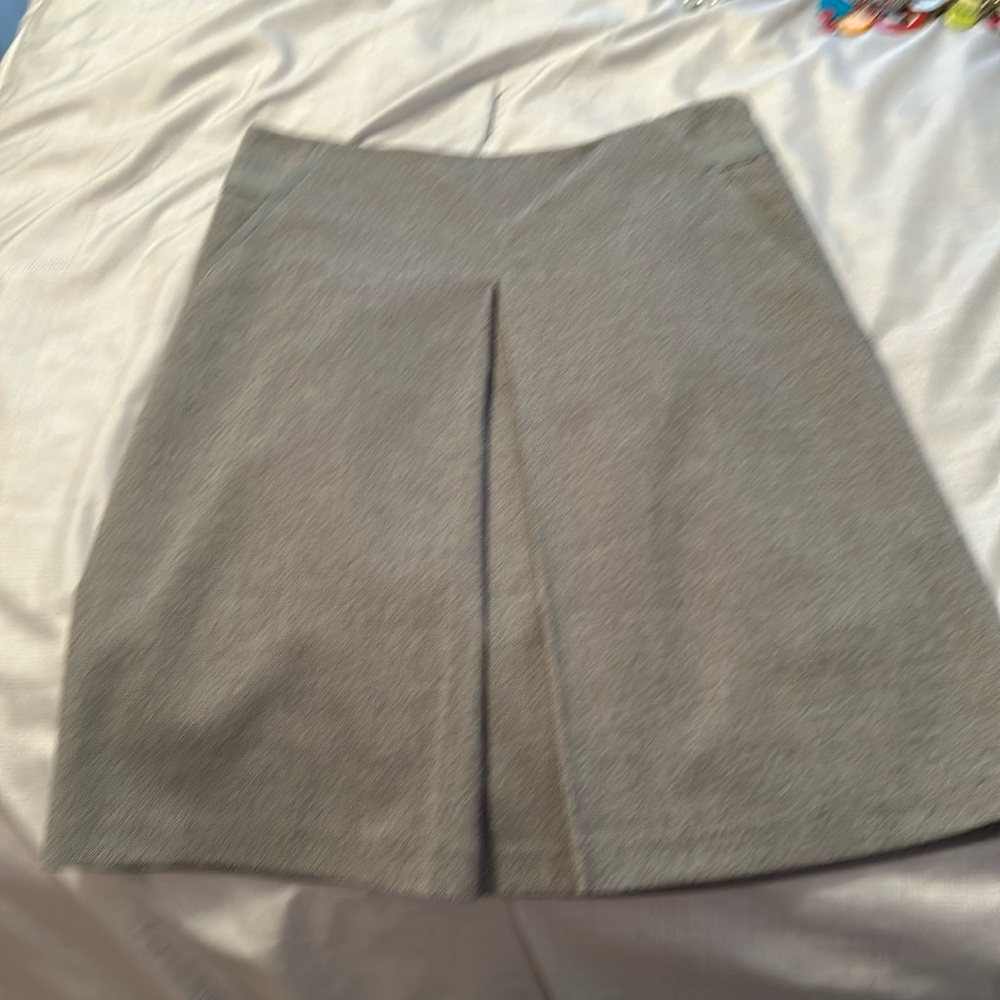 Size two pleated gray skirt.  Hits at knee.